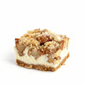 Apple spice cheesecake slice with crumbly topping on a white background.