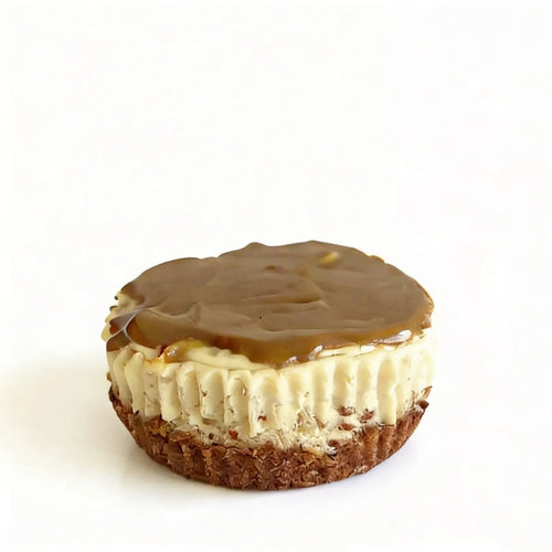 Mini cheesecake with caramel topping on a white background