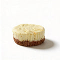 Mini cheesecake with a crumbly base on a white background
