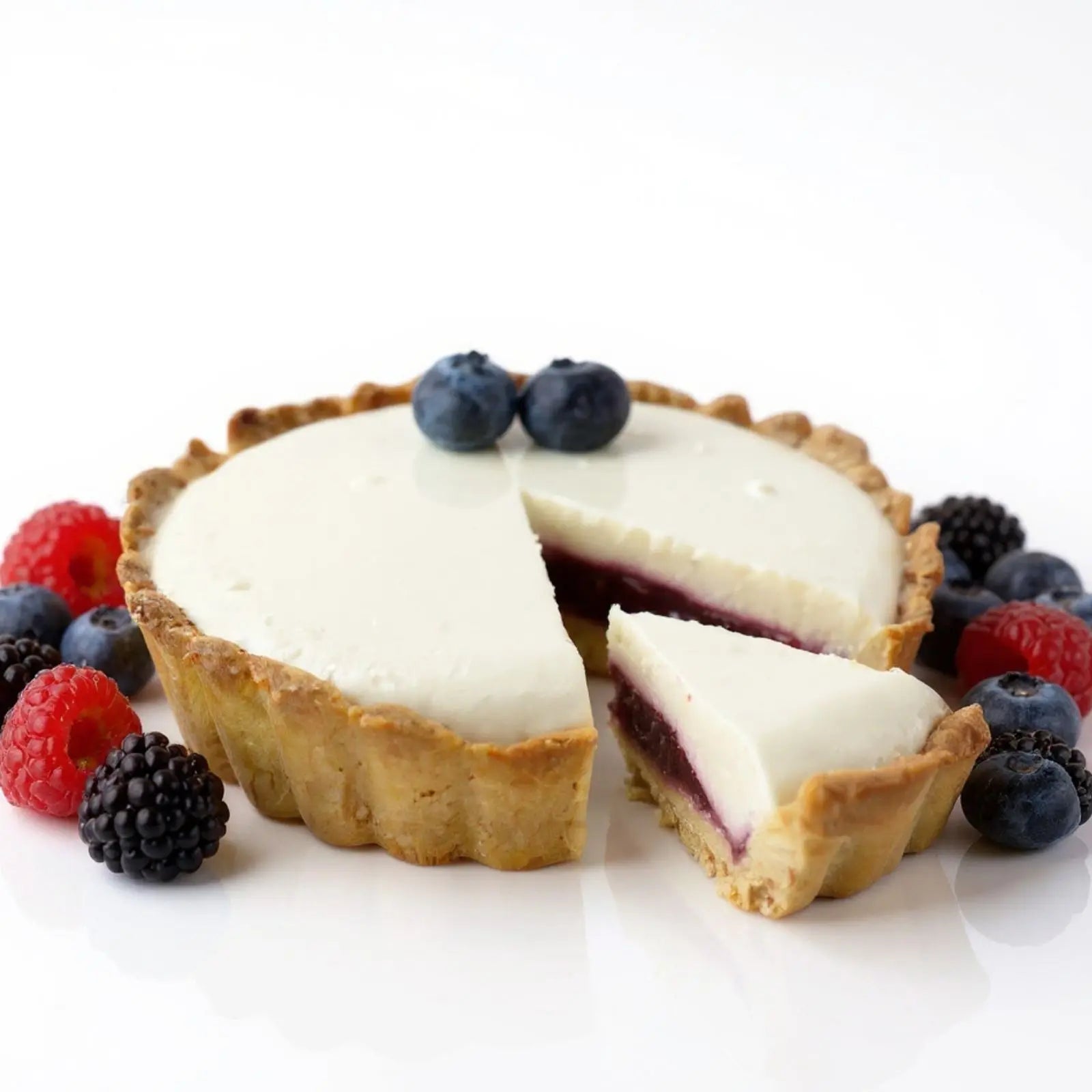 Emberly berry protein cheesecake tart with blueberries, raspberries and blackberries