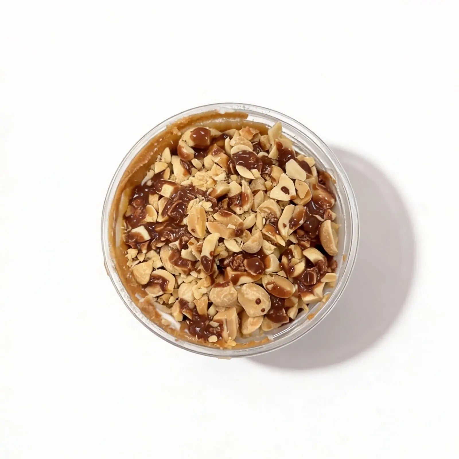 Top view of the chocolate peanut protein oatmeal and nuts on a white background