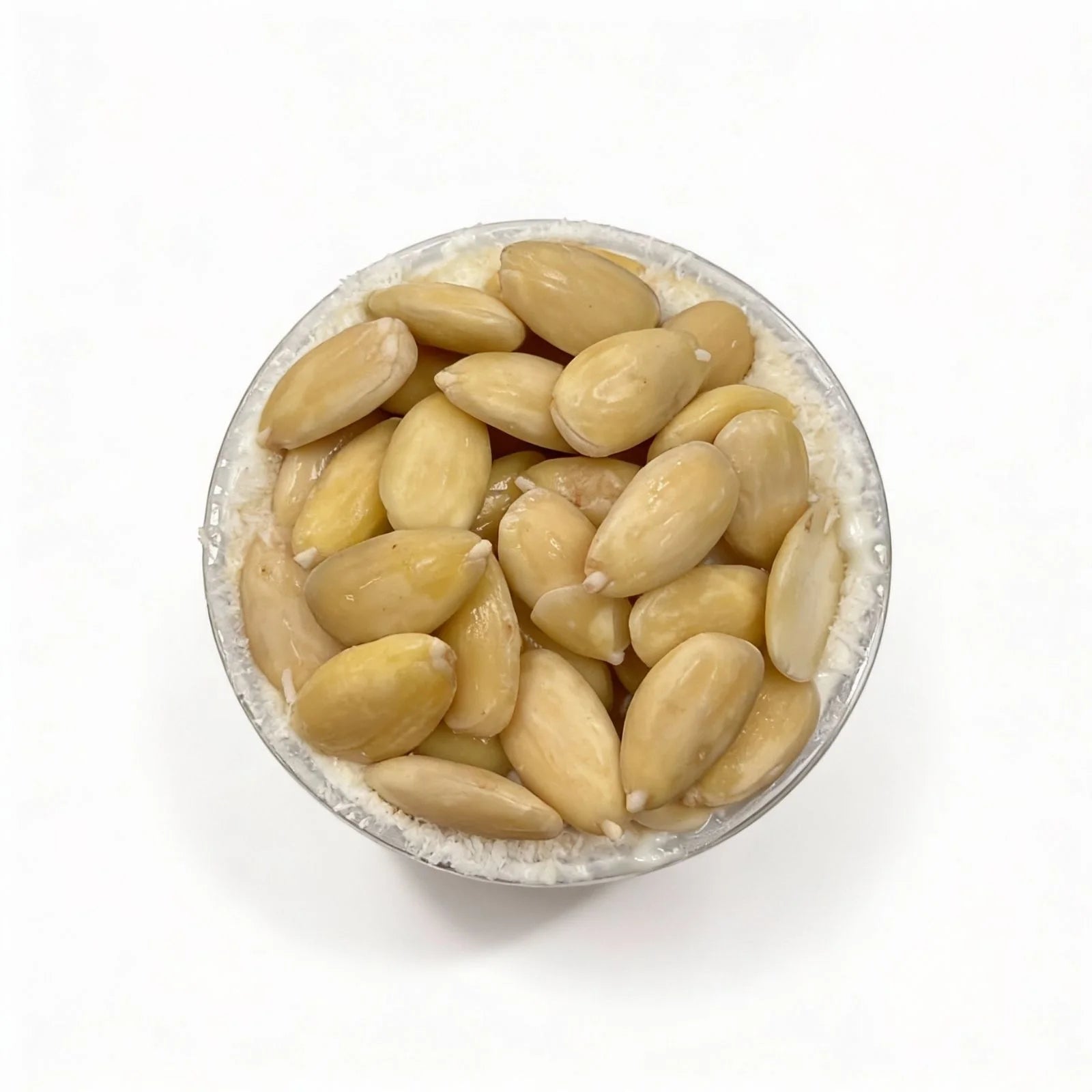 Cup filled with almonds on a top of the oatmeal dessert