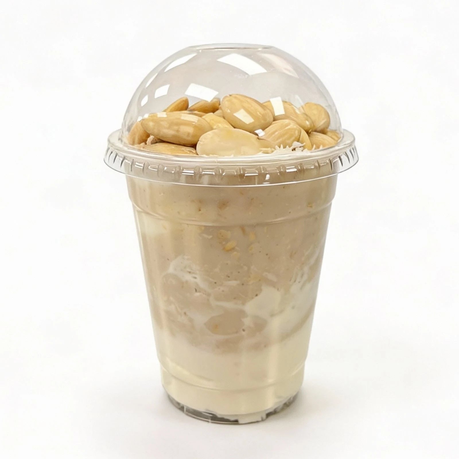 Clear plastic cup with a lid filled with almonds and coconut protein oatmeal on a white background