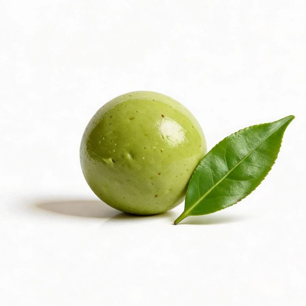 Matcha protein ball with a leaf on a white background