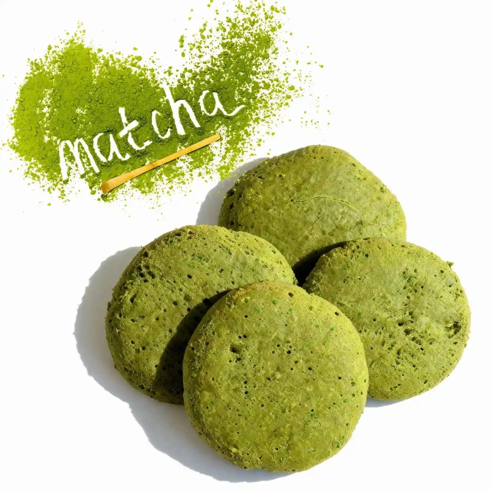 Hight protein organic matcha green tea cookies with matcha powder and a wooden spoon on a white background.